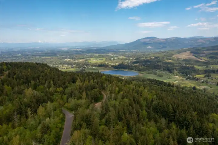 Aerial View looking at Squalicum Lake, Valley, with the Canadian Coastal Mountain range in the distance