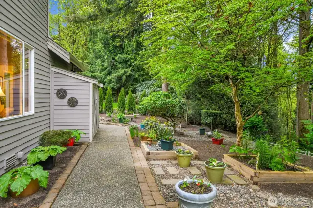 Rain Bird® replaced in 2023: two zones in front and two zones in back. Convenient, extended aggregate walkway from front to back. Storage shed in back. Private back yard with garden arbor. Raised garden beds.