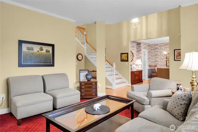 Formal living room off dramatic entry foyer. 9-foot ceiling with crown molding. Rich, designer carpet.