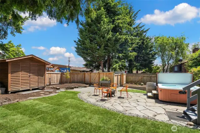 A garden shed and plenty of gardening space.