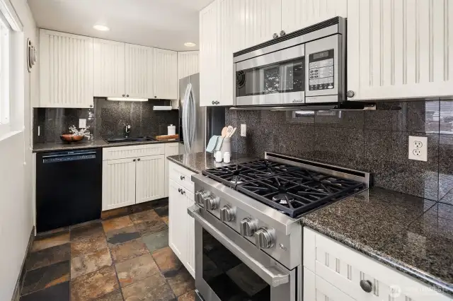 Cooks will love the stylish kitchen with slate floors, granite surfaces, and high-end stainless appliances including a Dacor Professional gas range and microwave.
