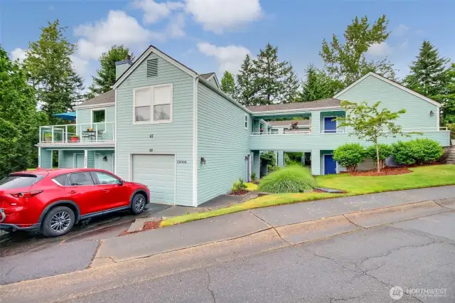 Craftsman style building with parking in front of your private garage
