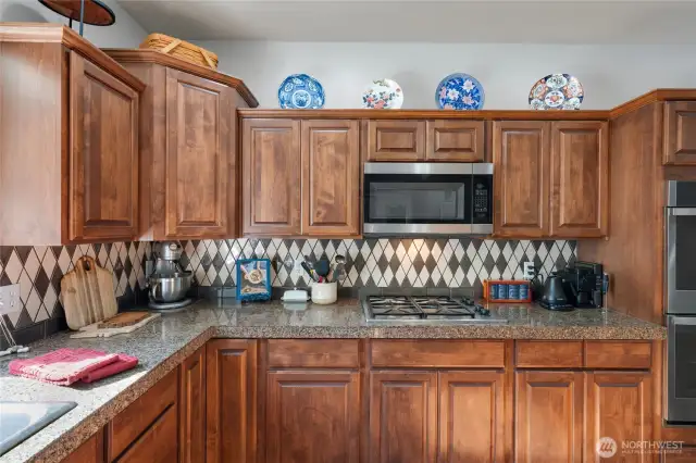 Fully updated kitchen with granite counters and designer tile backsplash.
