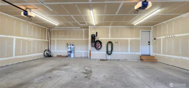 Expansive 3-car garage with storage hooks, central vacuum system for the whole house, and easy access to sprinkler system