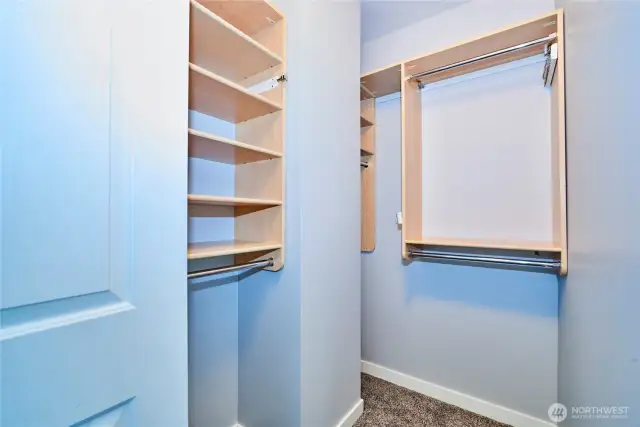 The walk in closet in the bedroom offers a custom closet system for maximum space efficiency.