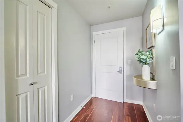 A look at the entry of the unit with a coat closet to the left and a cool built in shelf to the right.