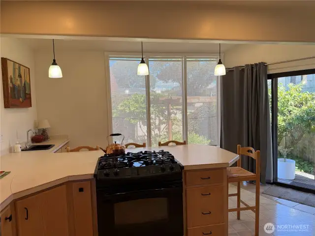 Angle of the kitchen looking toward the windows and sliding door.