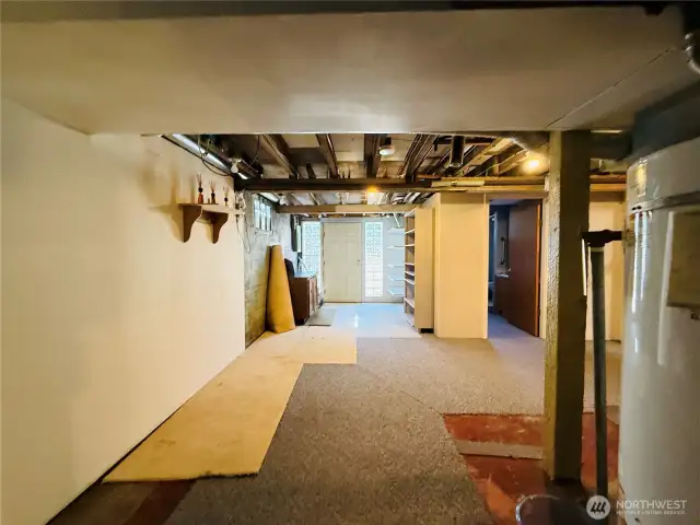 Another part of the basement looking towards the door to the outside,