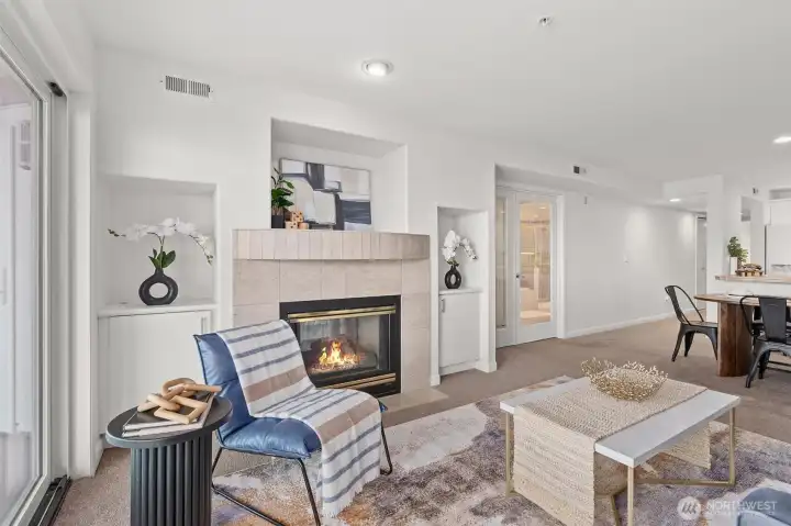 The two-sided gas fireplace opens to the living room and the Primary Suite.