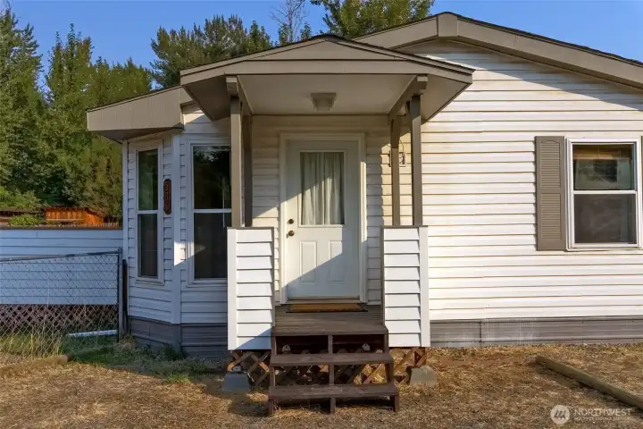 Covered porch entry to your modest 3 bedroom home.