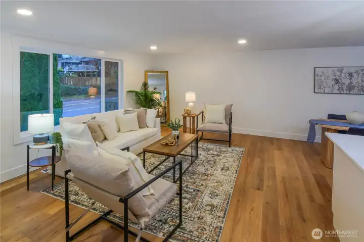 Bright, fully remodeled living room featuring wide-plank flooring, fresh finishes, and an open layout perfect for everyday living and entertaining.