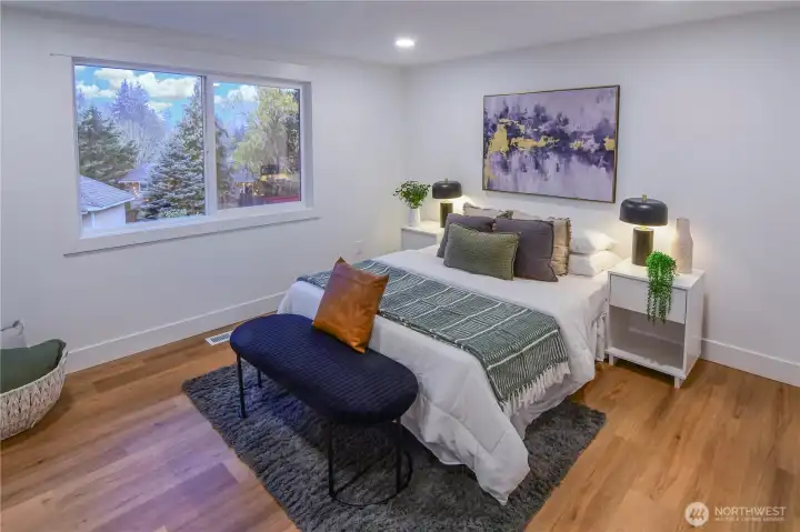 Main-floor primary bedroom with peaceful backyard views and an oversized closet for generous storage.