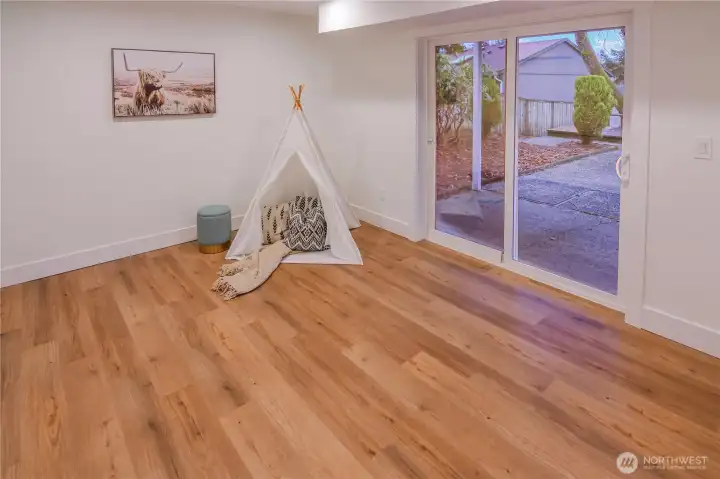 Large lower-level bedroom with sliding door access to the backyard—ideal as a guest room, teen suite, or flexible bonus space.