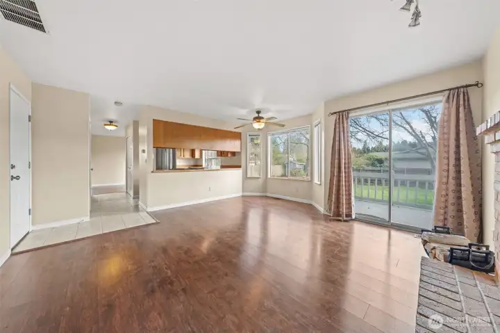Another focal point of the family room is its open connection to the kitchen, creating a natural gathering space for everyday living. The breakfast nook and pass-through window make it easy to stay connected while preparing meals, and the sliding glass door offers direct access to the backyard deck for effortless entertaining.