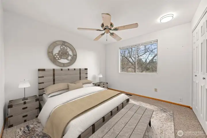 Bedroom Two features soft neutral tones, plush carpeting, and a large window that fills the space with natural light. The layout offers comfort and flexibility for your ideal bedroom design.