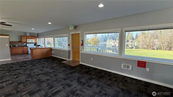 Clubhouse Two offers a bright, open gathering space with large windows overlooking the grounds, plus an adjoining kitchen ideal for hosting events and community gatherings.