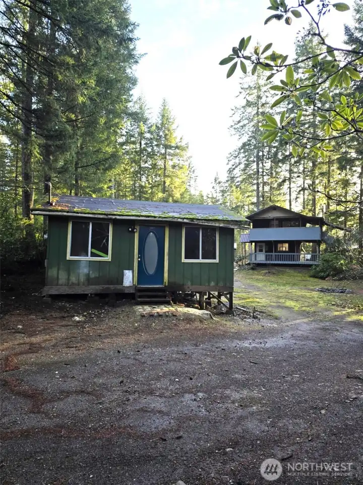 Lot #55 Cabin, and 2-story house on Parcel #56 in the background