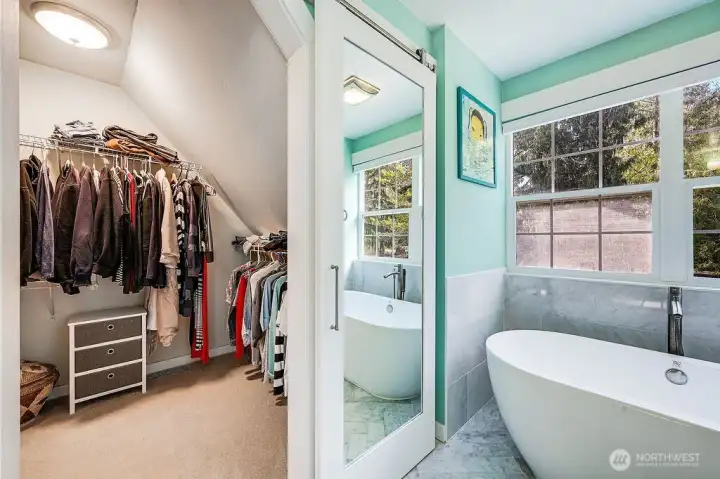 The closet is huge and expands behind the shower.