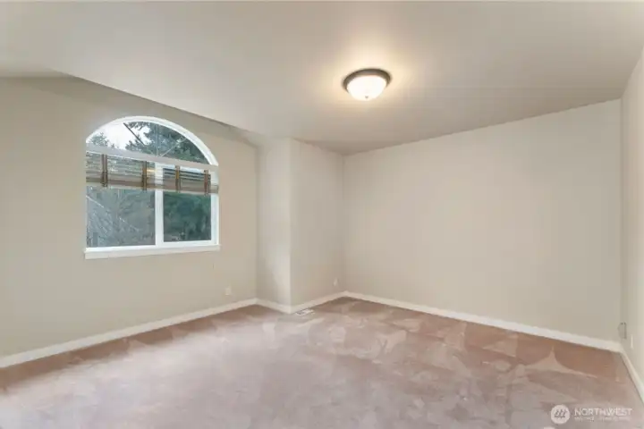 Spacious large bedroom over the garage south facing for lots of sun! Photo depicts the room without furniture; seller furnishings are currently in the home.