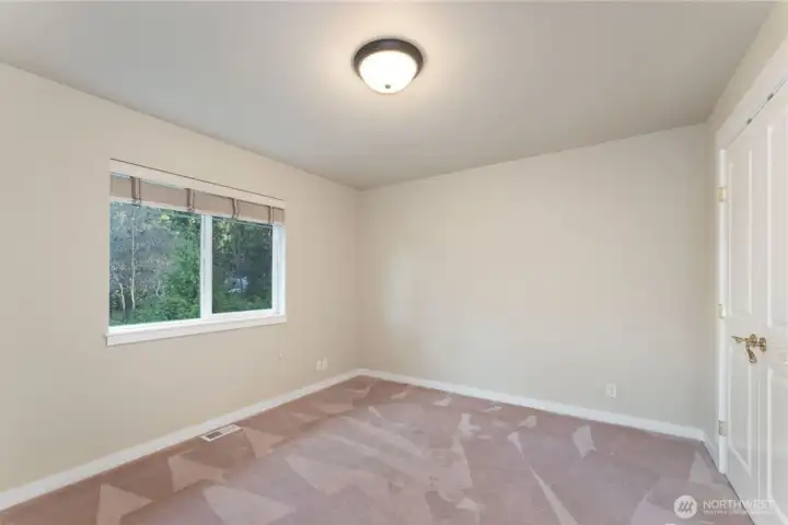 3rd bedroom - facing east. Photo depicts the room without furniture; seller furnishings are currently in the home.