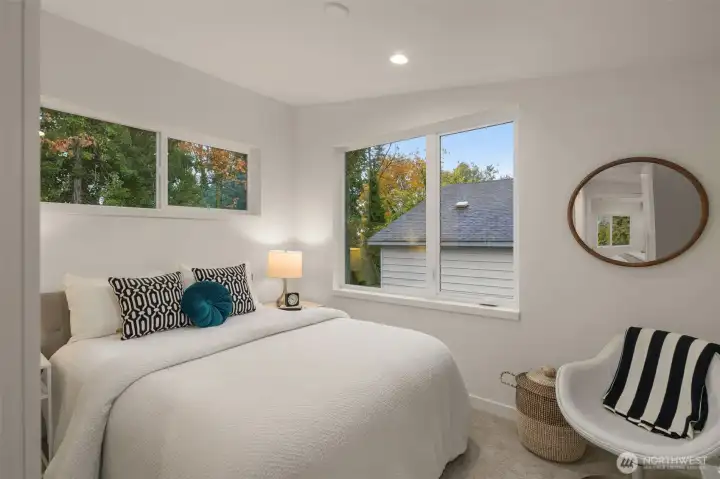 Down the hall, a spacious secondary bedroom. Perfect for guests or doubles as a large open office or hobby room
