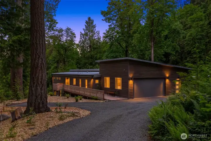 Modern architecture meets Pacific Northwest serenity, with warm light spilling into a forest setting that feels equal parts retreat and sanctuary. Modern architecture meets Pacific Northwest serenity, with warm light spilling into a forest setting that feels equal parts retreat and sanctuary.