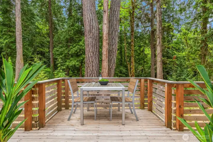 Tranquil outdoor space just off the entry deck—perfect for enjoying a morning coffee or an evening glass of wine among the towering evergreens. Tranquil outdoor space just off the entry deck—perfect for enjoying a morning coffee or an evening glass of wine among the towering evergreens.