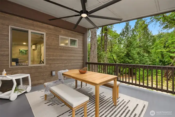 Covered upper deck with ceiling fan creates a peaceful outdoor living room nestled among the trees. Covered upper deck with ceiling fan creates a peaceful outdoor living room nestled among the trees.