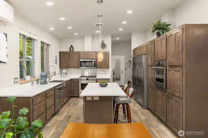 A beautifully functional kitchen at the heart of the home, thoughtfully appointed with extensive cabinetry, oversized island seating, and professional-grade appliances for effortless entertaining. A beautifully functional kitchen at the heart of the home, thoughtfully appointed with extensive cabinetry, oversized island seating, and professional-grade appliances for effortless entertaining.