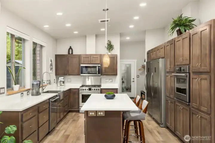 A generous chef’s kitchen with oversized island, dual ovens, and abundant storage designed for cooking, gathering, and everyday living. A generous chef’s kitchen with oversized island, dual ovens, and abundant storage designed for cooking, gathering, and everyday living.