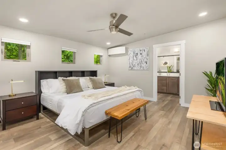 The spacious primary suite offers a calming, retreat-like atmosphere with forested outlooks, generous proportions, and a beautifully integrated ensuite bath designed for daily ease. The spacious primary suite offers a calming, retreat-like atmosphere with forested outlooks, generous proportions, and a beautifully integrated ensuite bath designed for daily ease.
