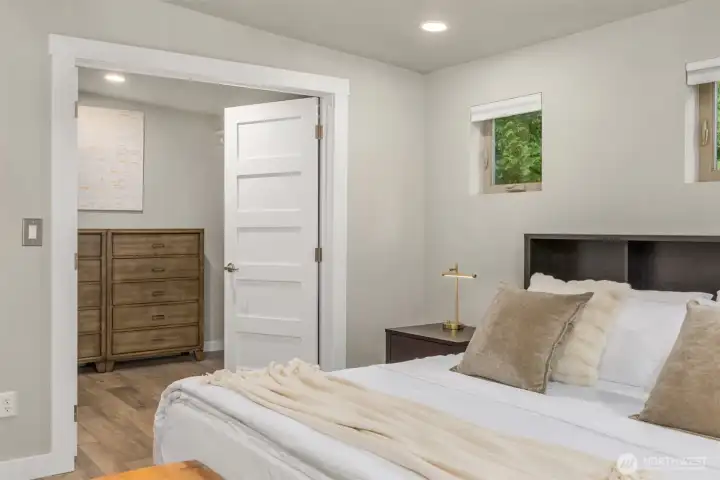 Generous walk-in closet with ample hanging space and room for additional wardrobe storage or custom organization systems. Generous walk-in closet with ample hanging space and room for additional wardrobe storage or custom organization systems.