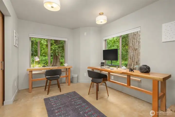 Surrounded by peaceful woodland views, the ADU study provides an inspiring workspace with custom built-ins and a calming connection to nature. Surrounded by peaceful woodland views, the ADU study provides an inspiring workspace with custom built-ins and a calming connection to nature.