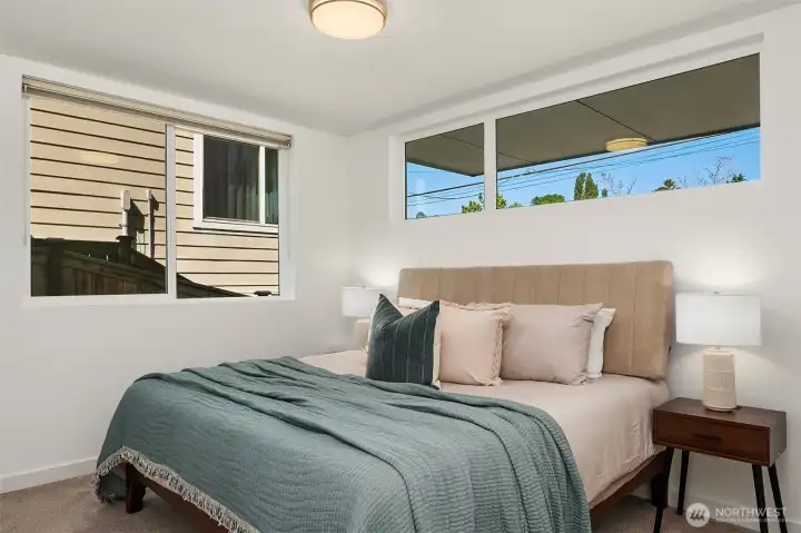 Lower-level secondary bedroom with natural light and flexible use for guests, roommates, office, or longer visits.