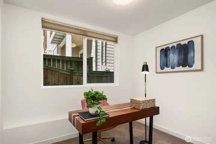 Flexible third bedroom staged as a home office, ideal for remote work, guests, or additional sleeping space.
