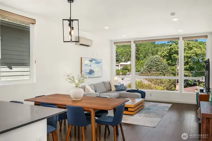 Dining area comfortably seats and can accommodate 8 person dining table.