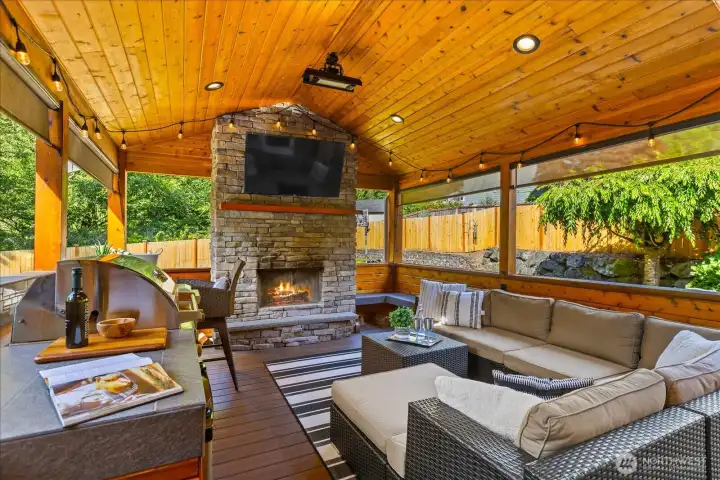 Stunning outdoor room features wood fireplace with gas starter; gas barbecue and two stianless gas burners; beverage refrigerator; heaters and mounted TV. Stunning outdoor room features wood fireplace with gas starter; gas barbecue and two stianless gas burners; beverage refrigerator; heaters and mounted TV.