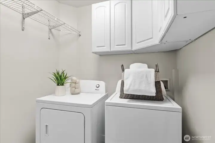 Lower level laundry room with storage and hanging space Lower level laundry room with storage and hanging space