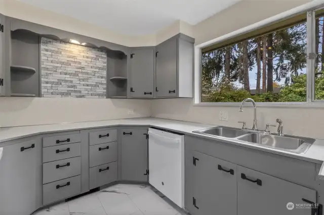 Lots of counter, cabinet and drawer space in the kitchen, and a great view out to the backyard.