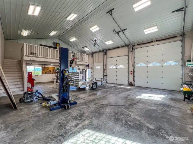 A shot into the 1418 Sq Ft 2X6 constructed shop with the doors up. The shop is complete with a hoist and air compressor and loft area. The shop is heated and is sure to be a favorite to all.