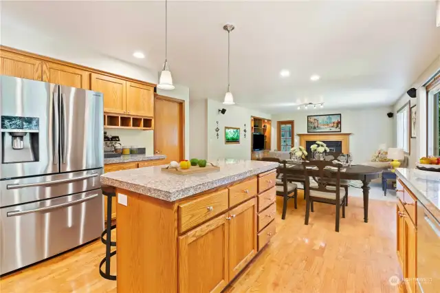 Kitchen with newer stainless-steel appliances flows into the family room