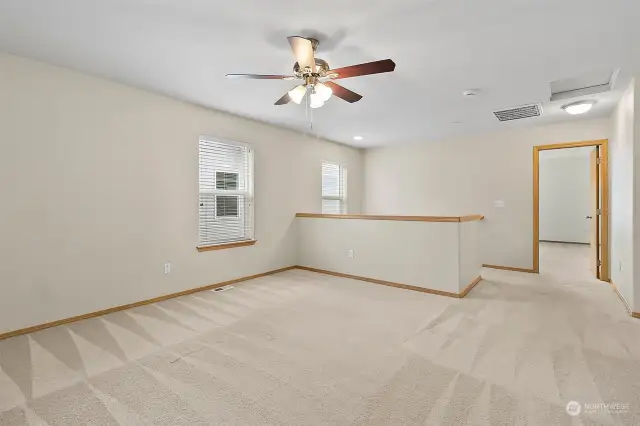 Upstairs Bonus / Loft Area with Ceiling Fan (1 of 3 in the home). Located off the Primary Bedroom and Separates the Floorplan from the Other Bedrooms and Full Bath. Upstairs Laundry in the Hallway Not Pictured