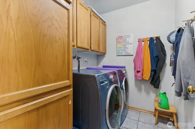 Laundry room with plenty of storage cabinets