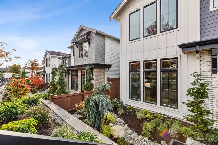 Terraced front with landscape lighting enhancing the thoughtful landscape.