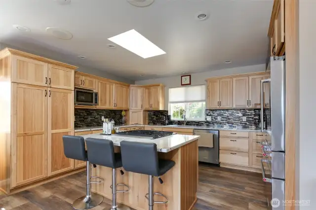 Check out the specialty cupboards. There are 2 garage appliance doors, a spice drawer, trash drawer in island, corner cabinets and a spacious pantry!