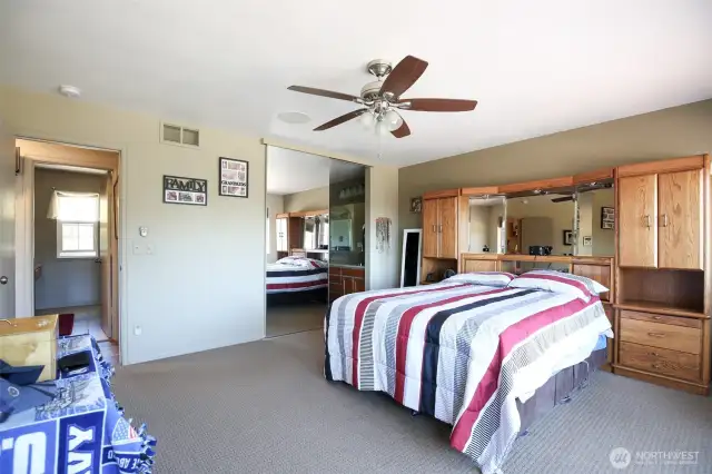 Main bedroom with ceiling fan and a view as well.