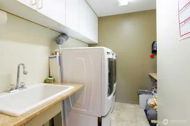 Downstairs Utility room with deep sink, just off 2 car garage. Washer and Dryer stays with home.
