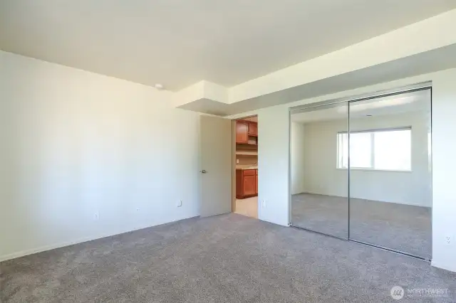 Downstairs bedroom with mirror closet doors