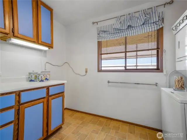 The laundry room has room for an extra refrigerator or freezer. Works pace to fold the laundry or do craft projects.