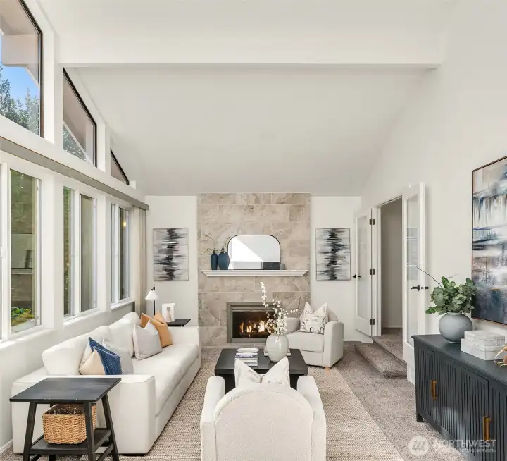 The formal Living Room is versatile as a gathering space. The fireplace was refreshed in 2018. New vinyl windows were also installed in 2018.